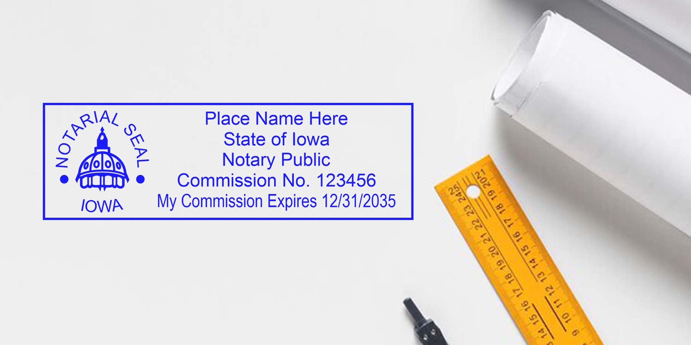 IA notary stamp with commission number and expiration date, showing the top Iowa notary stamp on a white background with a ruler and rolled paper.