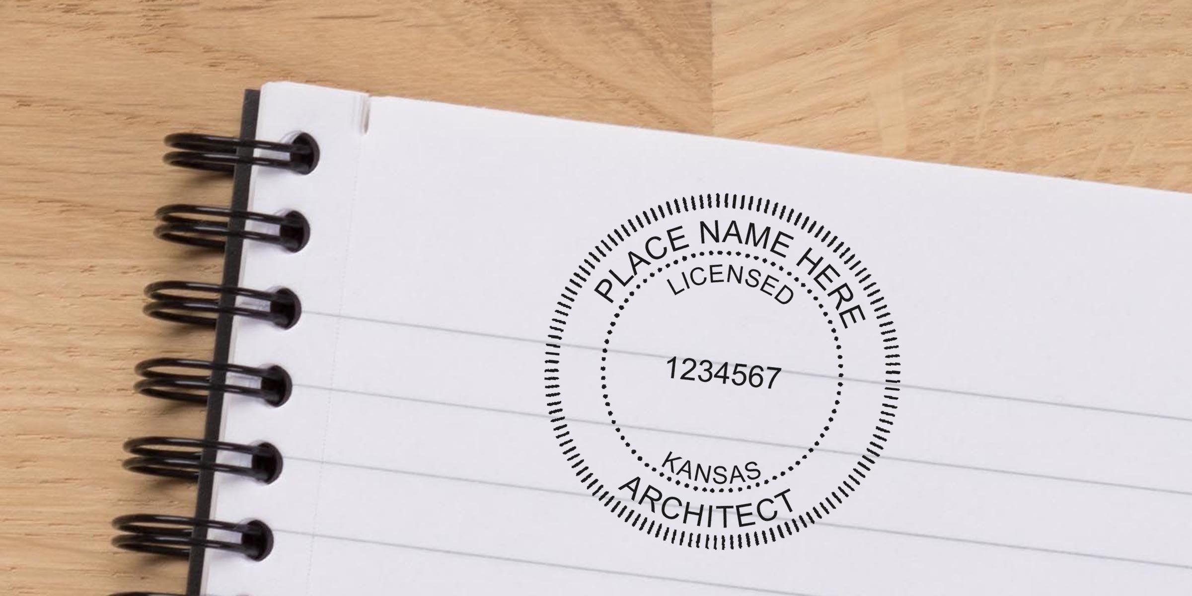 Kansas architect license stamp on a spiral notebook page with seals and embossers.