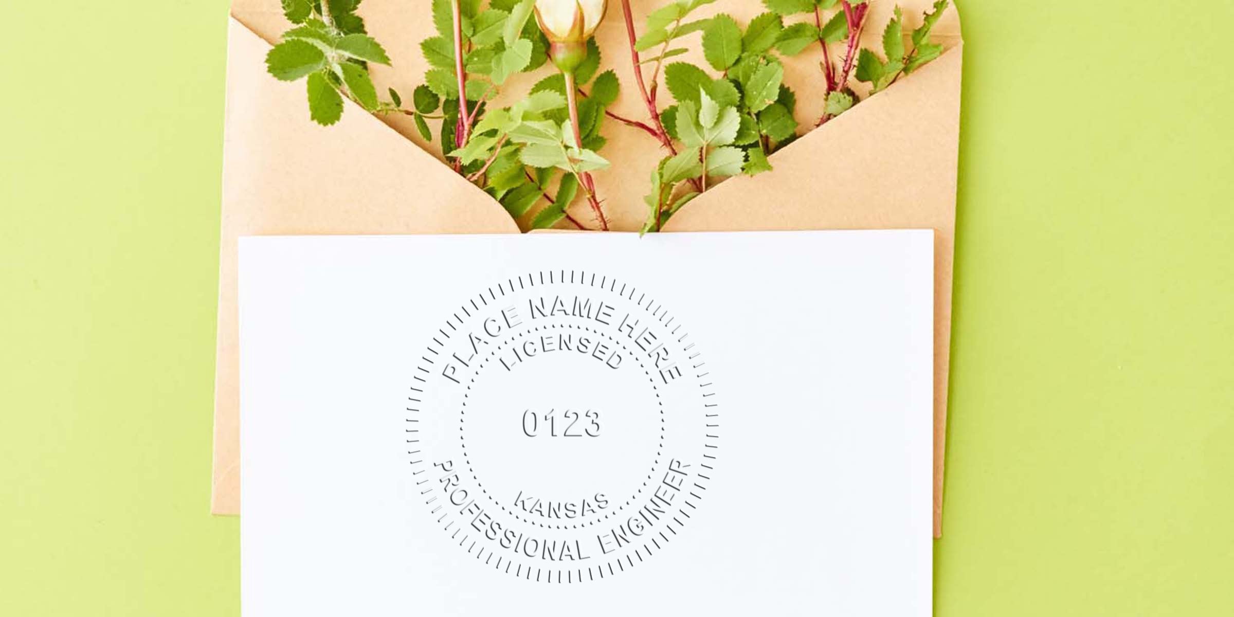 Envelope with green leaves and a Kansas engineer stamp on white paper, meeting engineer seal requirements.