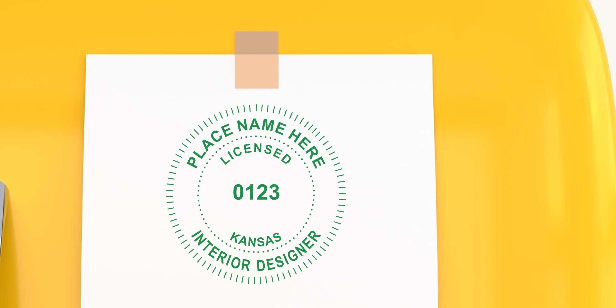 Licensed Kansas interior designer stamp on white paper with yellow background, emphasizing Kansas interior designer renewal and the stamp renewal process.