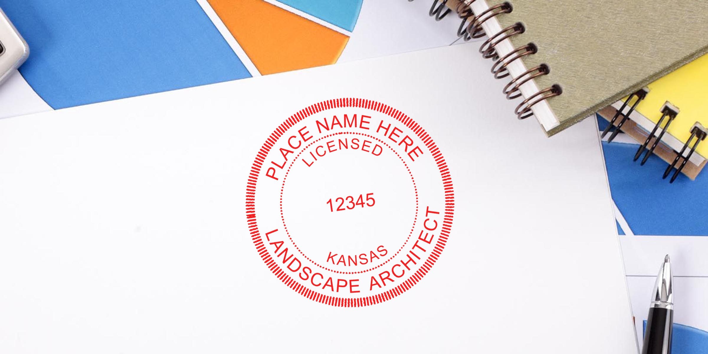 Kansas landscape architect stamp on white paper, surrounded by office supplies and notebooks, showing the stamp purchase process.
