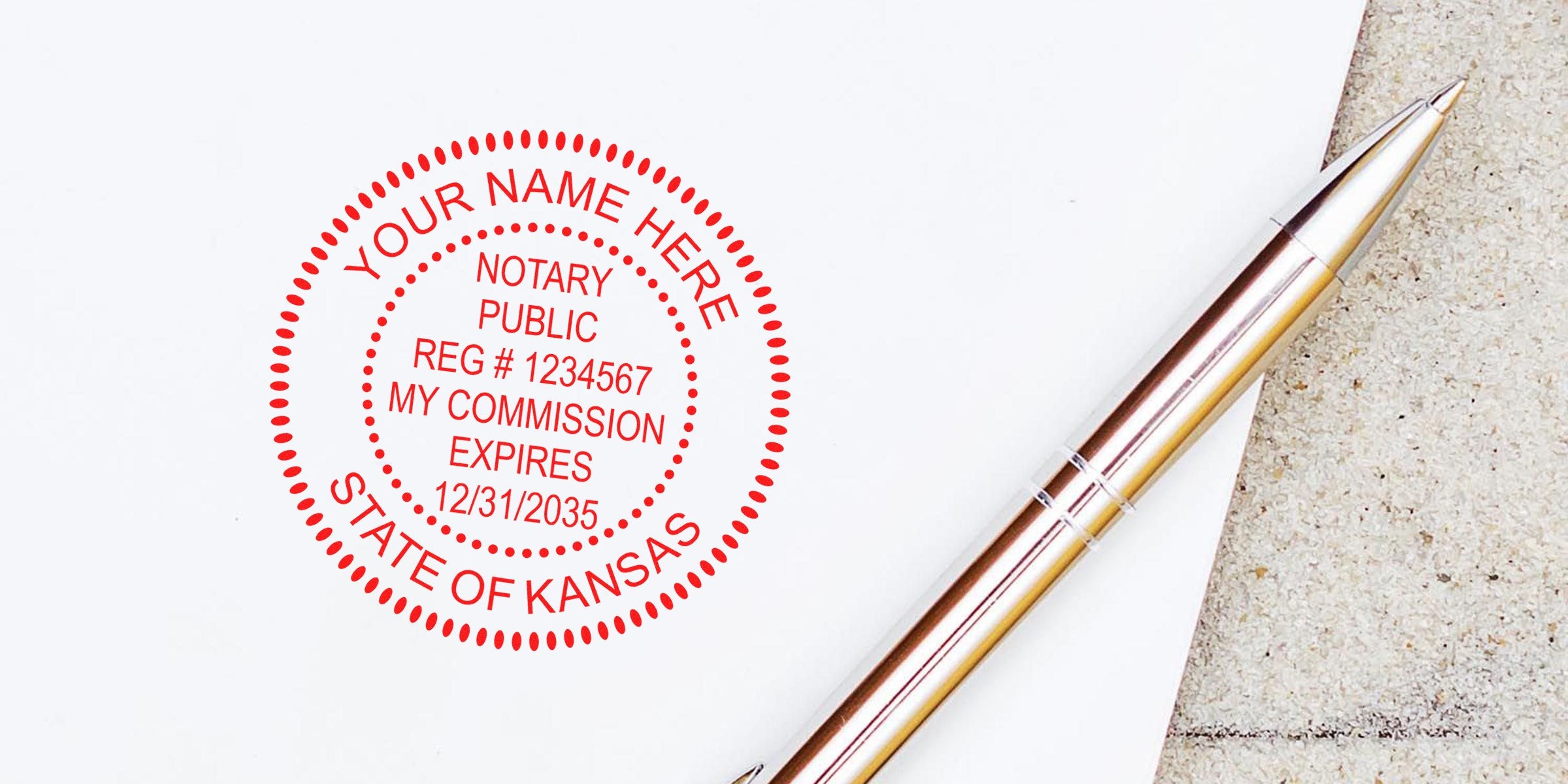 Kansas notary public stamp with commission expiration date next to silver pen on white paper, showcasing essential Kansas notary supplies from notary supplies online.