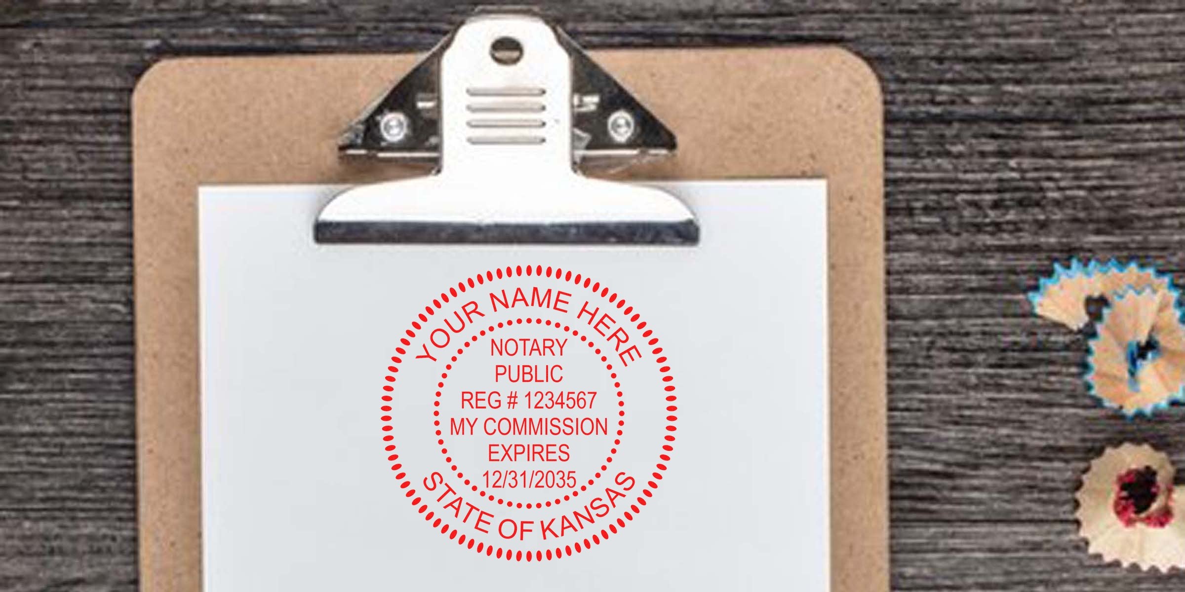 Kansas notary public stamp on clipboard with document, pencil shavings on wooden table, showing Kansas notary seal expiration and renewal details.