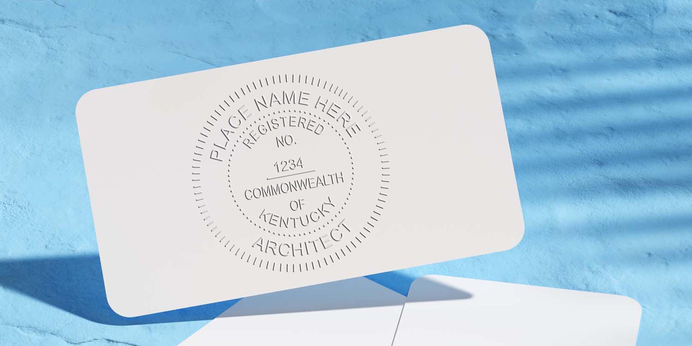 Embossed business card with Kentucky architect seal, professional design, and architect embosser on a blue background.