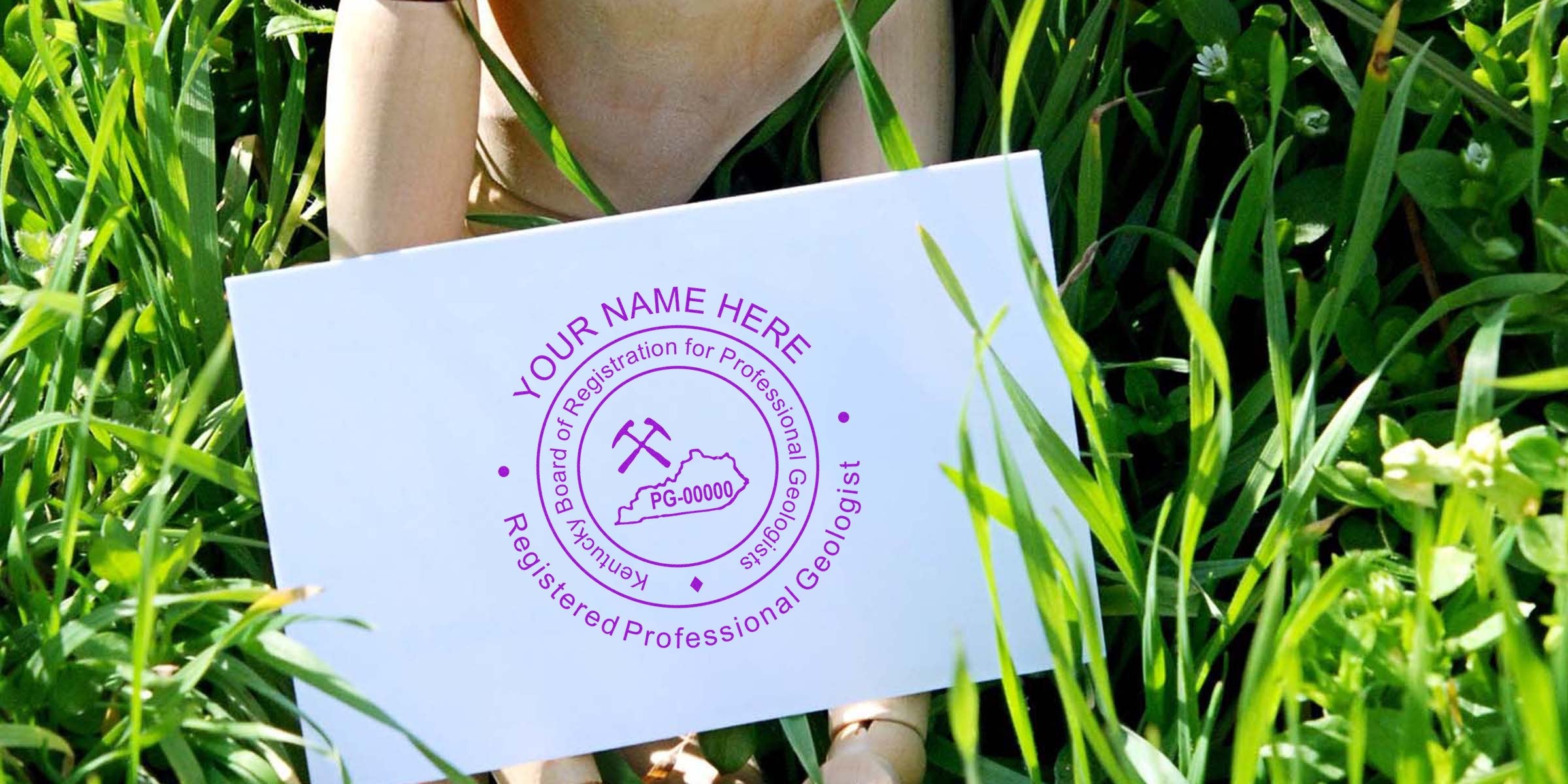 Kentucky Geologist Seal on a white card held in green grass, illustrating how to obtain the Geologist Seal in Kentucky.