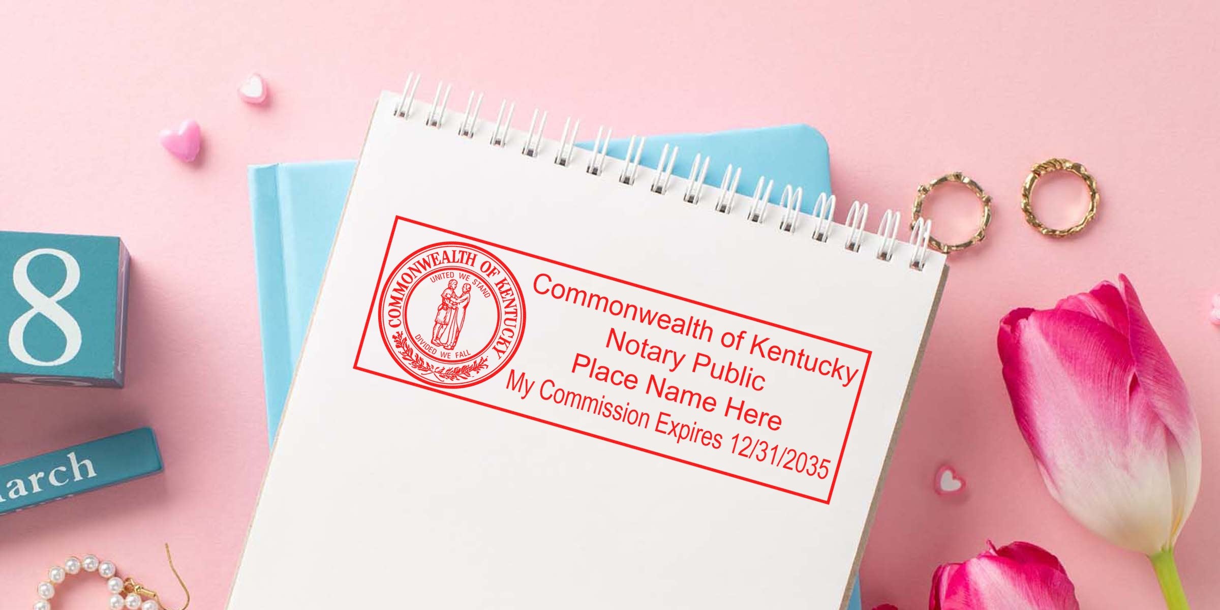 Kentucky notary stamp KY on a notebook with pink tulips and a March calendar block, highlighting budget-friendly notary stamp options.