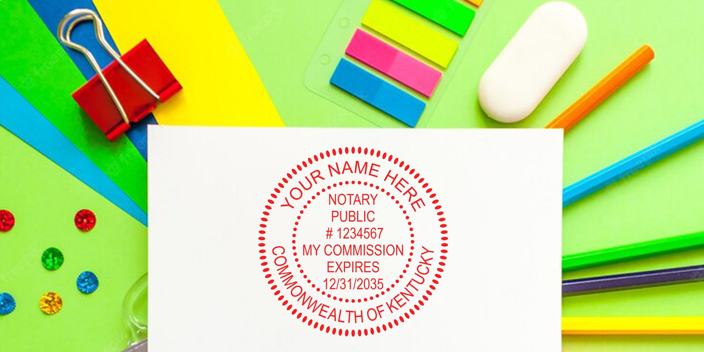 Kentucky notary seal stamp with commission expiration date on white paper, surrounded by colorful office supplies, meeting Kentucky notary seal requirements.