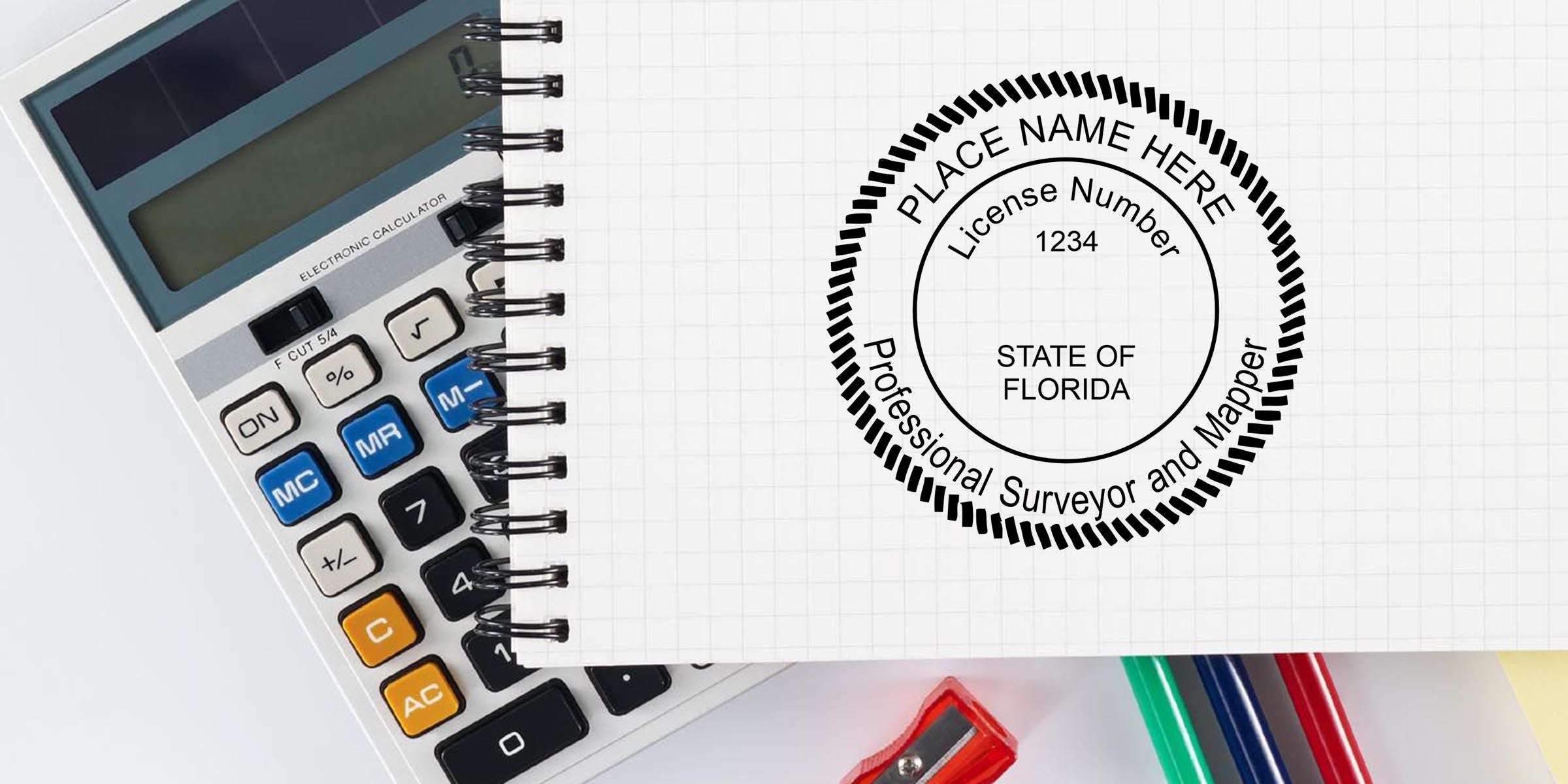Florida Professional Surveyor and Mapper license seal on a spiral notebook with calculator and colored pens, featuring place name placeholder and license number 1234.