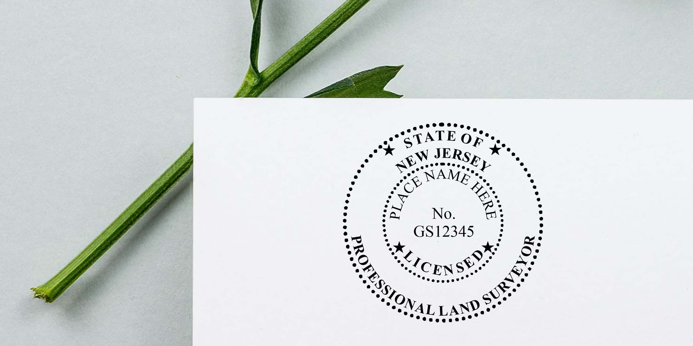 New Jersey professional land surveyor stamp on white paper with green plant stem in background, featuring license number GS12345 and place name placeholder.