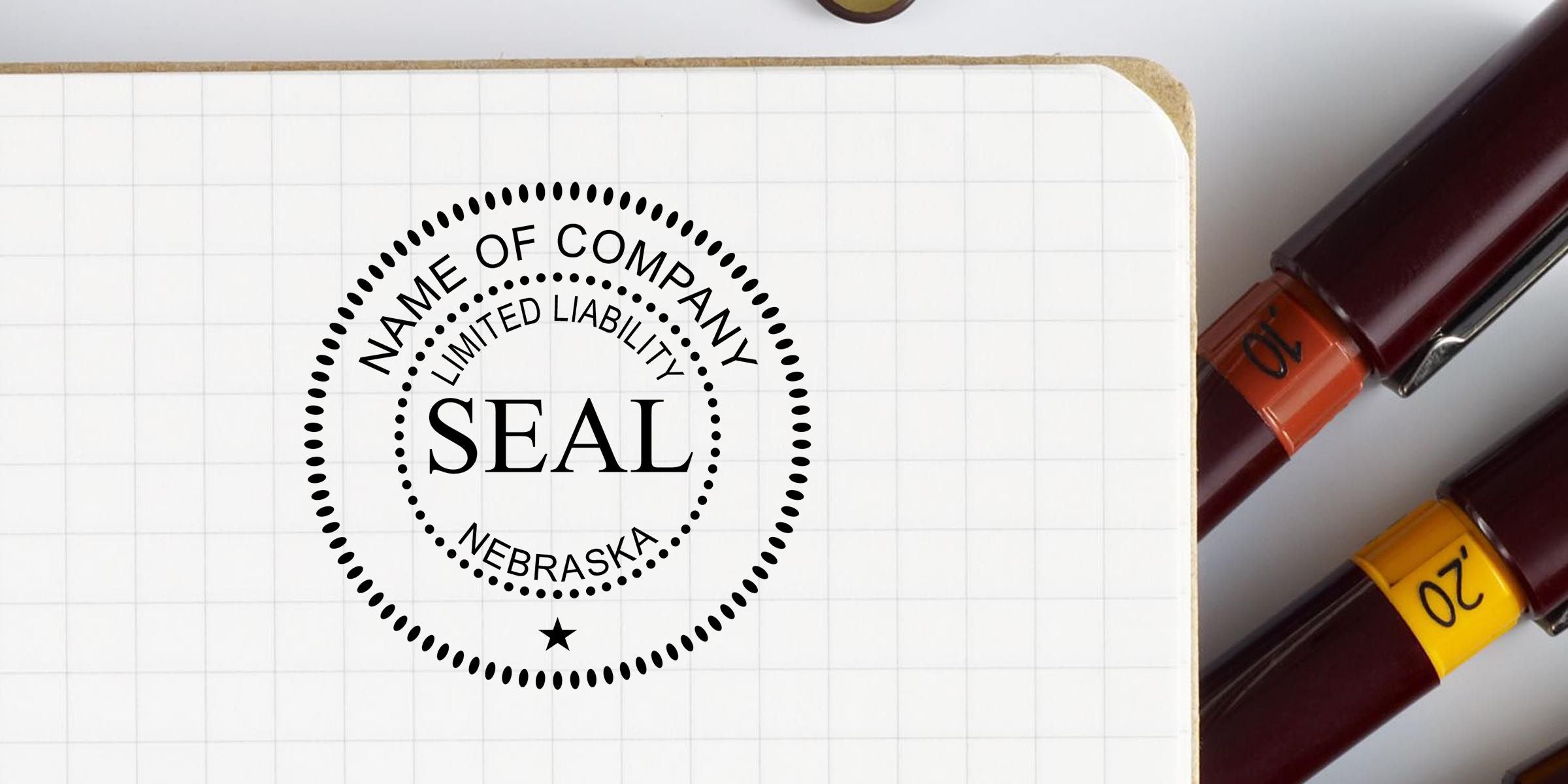 Nebraska limited liability company seal stamped on a graph paper notebook beside office pens and markers