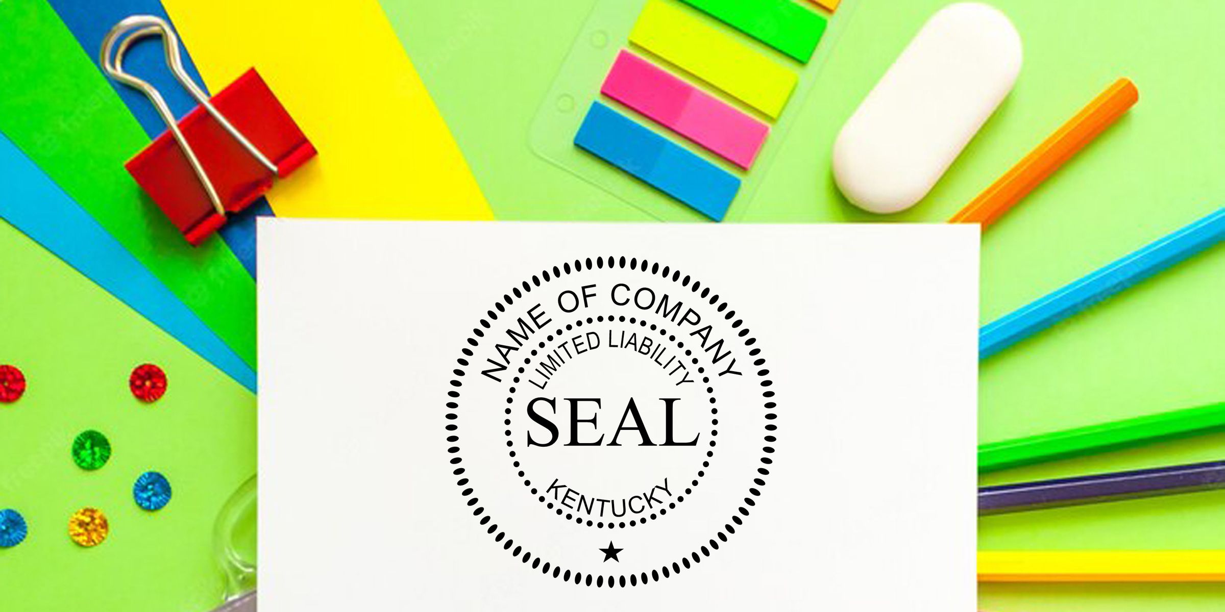 Kentucky limited liability company seal on white paper surrounded by colorful office supplies, binder clips, sticky notes, pencil, and paper clips on a bright green desk background