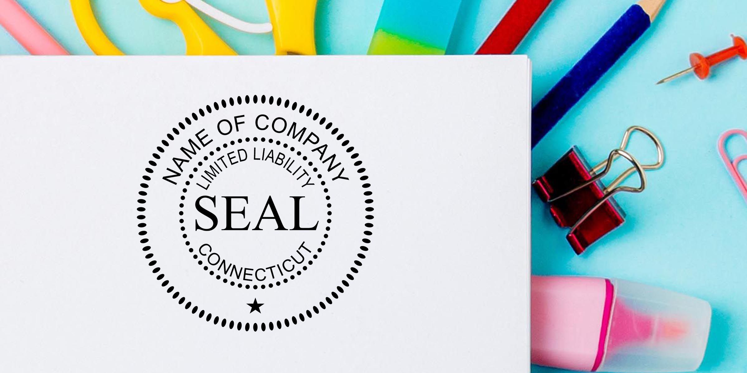 Blank white paper with company seal stamp surrounded by colorful office supplies on a blue background