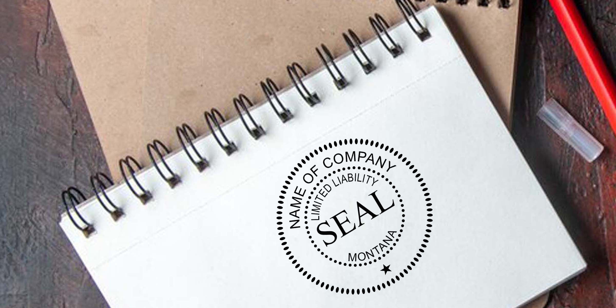 Spiral notebook with a company seal stamp reading limited liability company, blank business stationery on a desk with a pen and notebook in the background