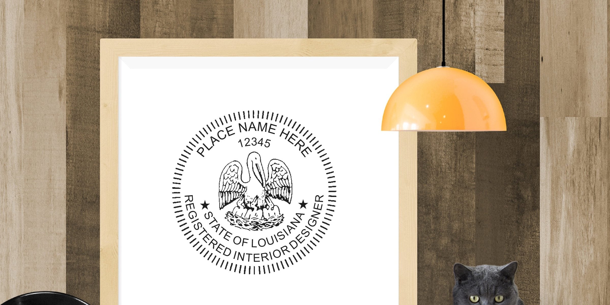 Louisiana registered interior designer seal framed on wooden wall, with modern orange pendant light above and gray cat below, showcasing Louisiana interior design regulations and seal requirements.