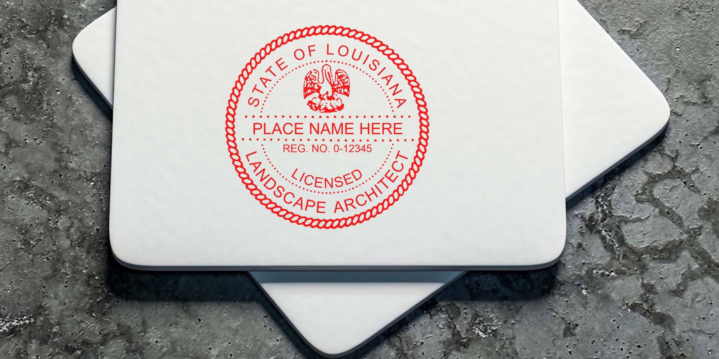 Louisiana landscape architect’s custom red seal stamp on white business cards, placed on textured gray concrete surface.