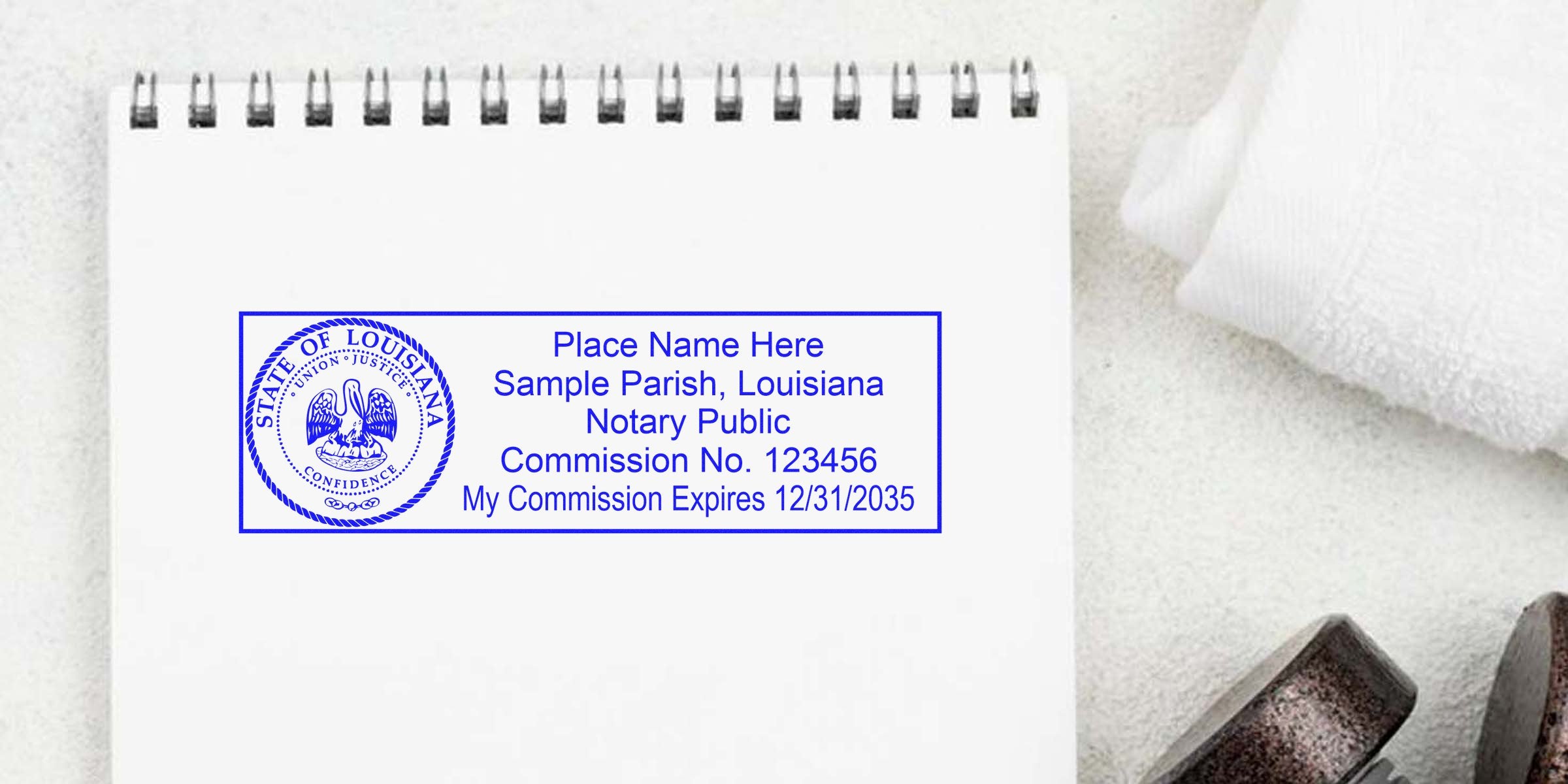 Louisiana notary seal with commission number and expiration date on a white spiral notebook, perfect for anyone seeking to buy a Louisiana notary seal.