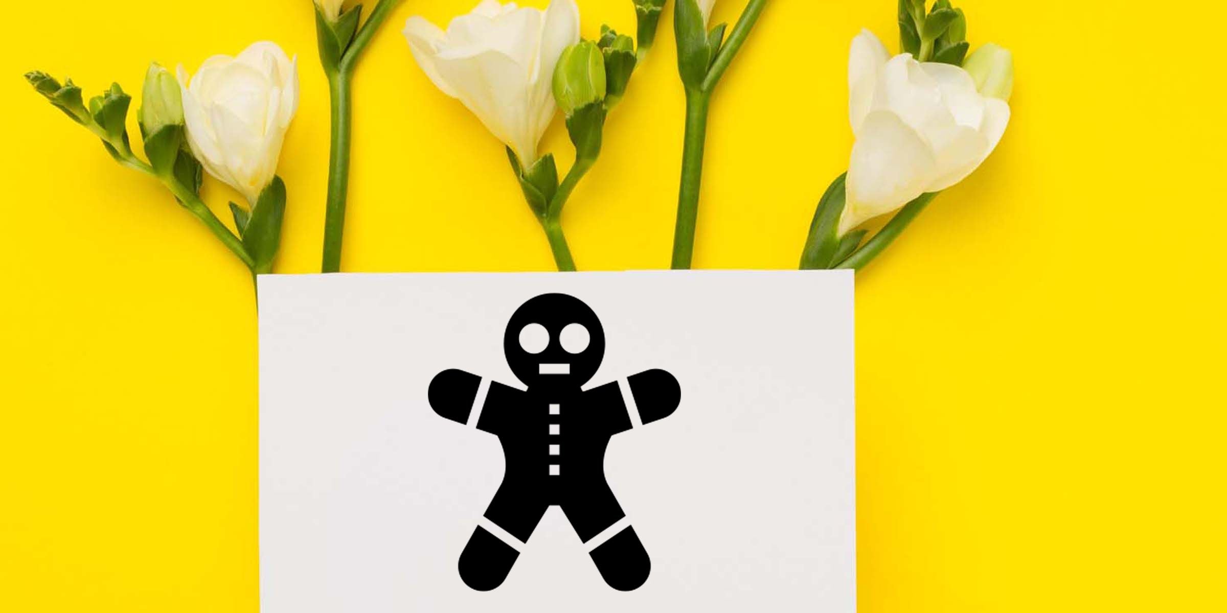 White flowers on a bright yellow background with a white card featuring a black gingerbread man icon and holiday baking theme