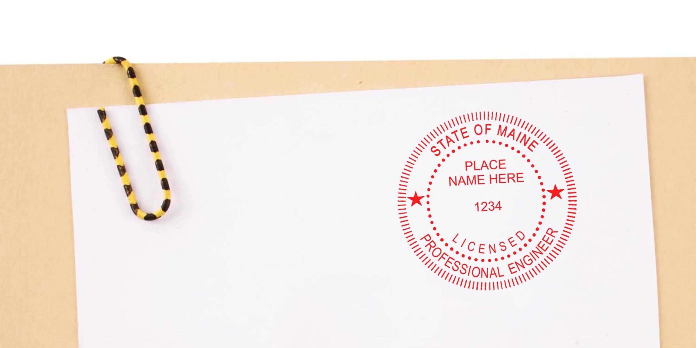 State of Maine licensed professional engineer stamp on white paper with yellow and black paperclip, showing stamp size and meeting Maine engineer stamp requirements.
