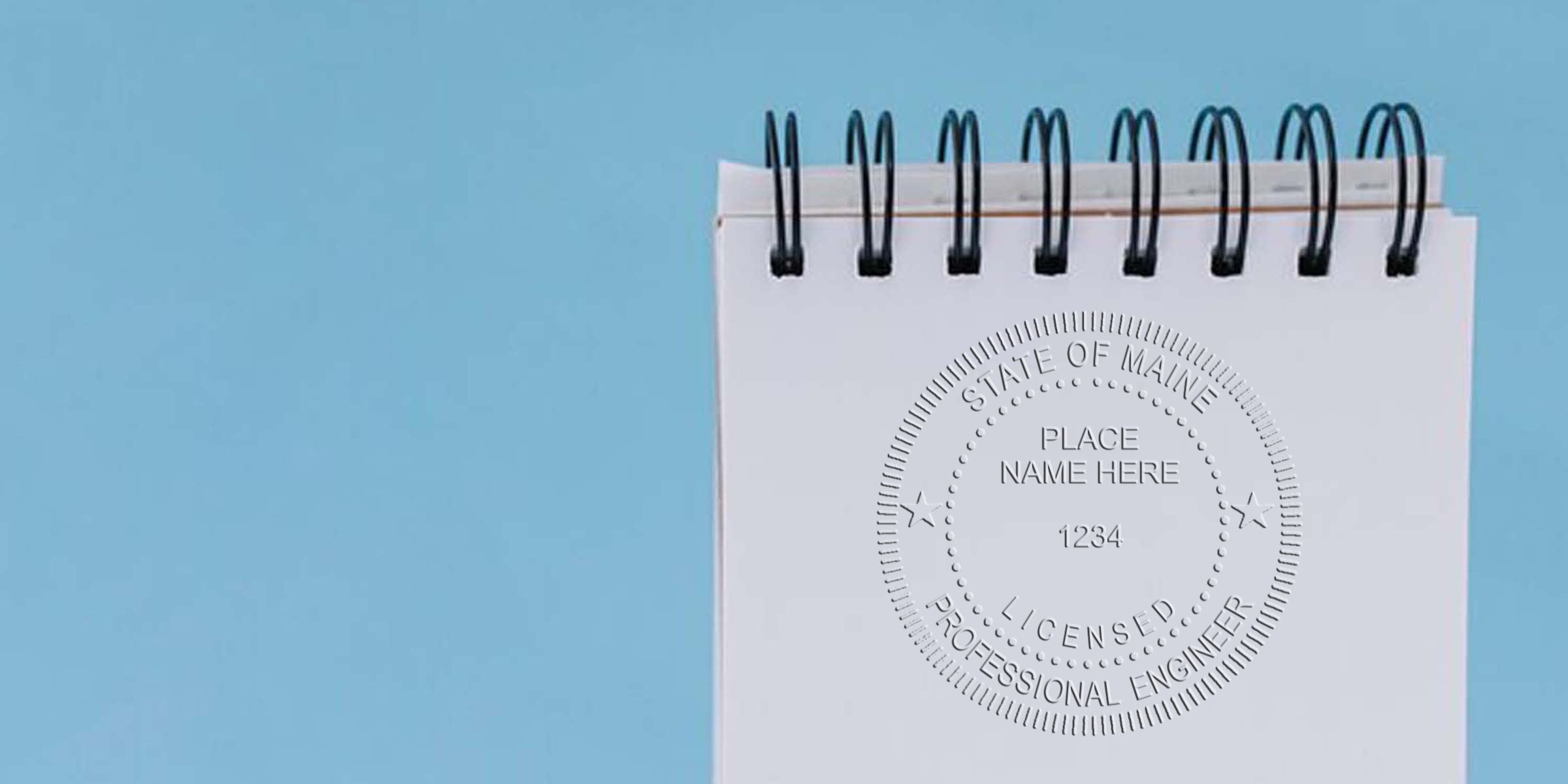 Maine engineer stamp template and project approval stamp with notary public seal on white spiral notebook against blue background.
