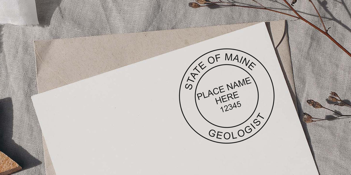 Envelope with Maine Professional Geologist Stamp, natural dried flowers, and linen fabric background, highlighting Geologist Certification Maine.