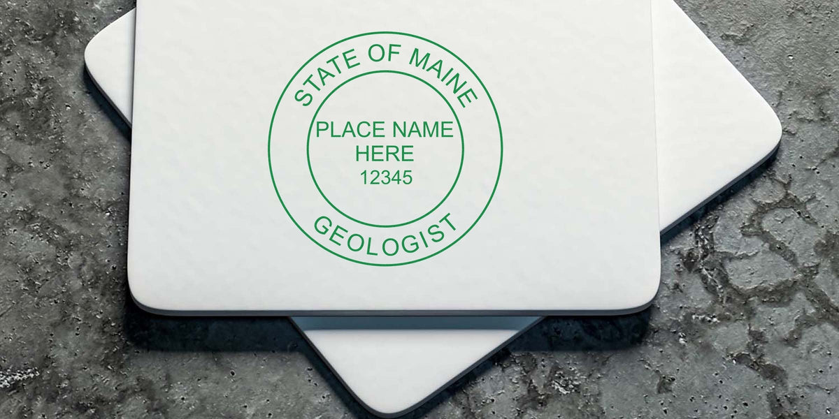 State of Maine geologist stamp on white paper set on concrete, featuring Maine Geologist Stamps and Geological Stamp Designs.