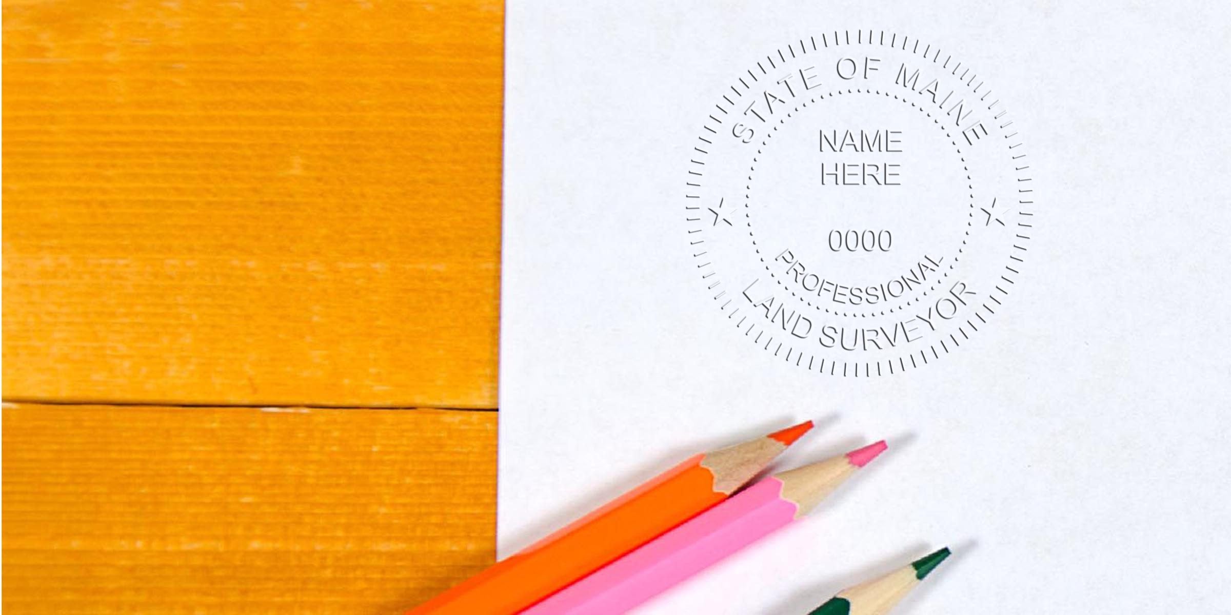 Professional land surveyor seal on white paper with colored pencils on a wooden table, illustrating Maine land surveyor stamp laws and regulations.