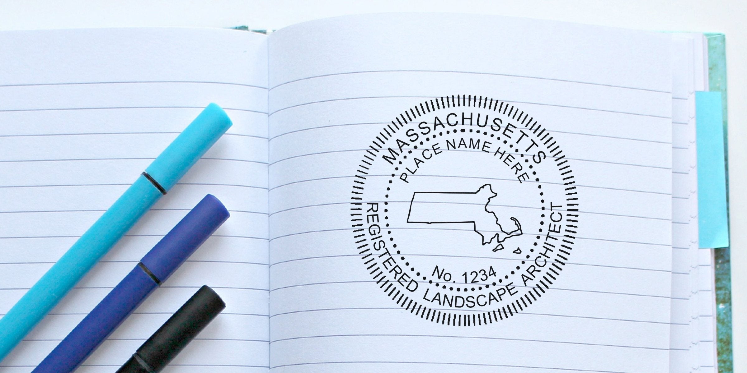 Massachusetts landscape architect stamp on notebook with blue pens, showing architect seal and stamps, next to Maine landscape architect materials.