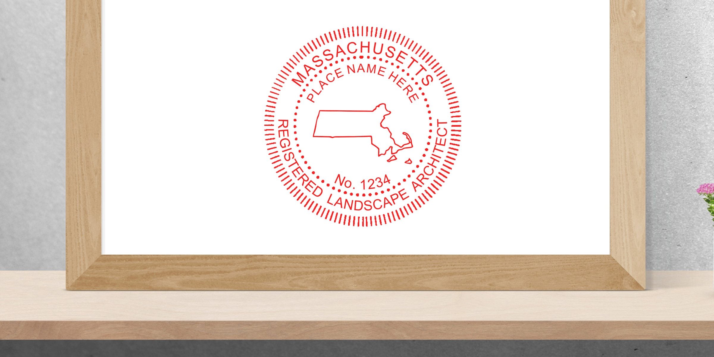 Massachusetts landscape architect stamp with state outline in wooden frame on shelf, next to Landscape Architect Stamp Maine and Maine Legal Requirements Landscape Architecture materials.