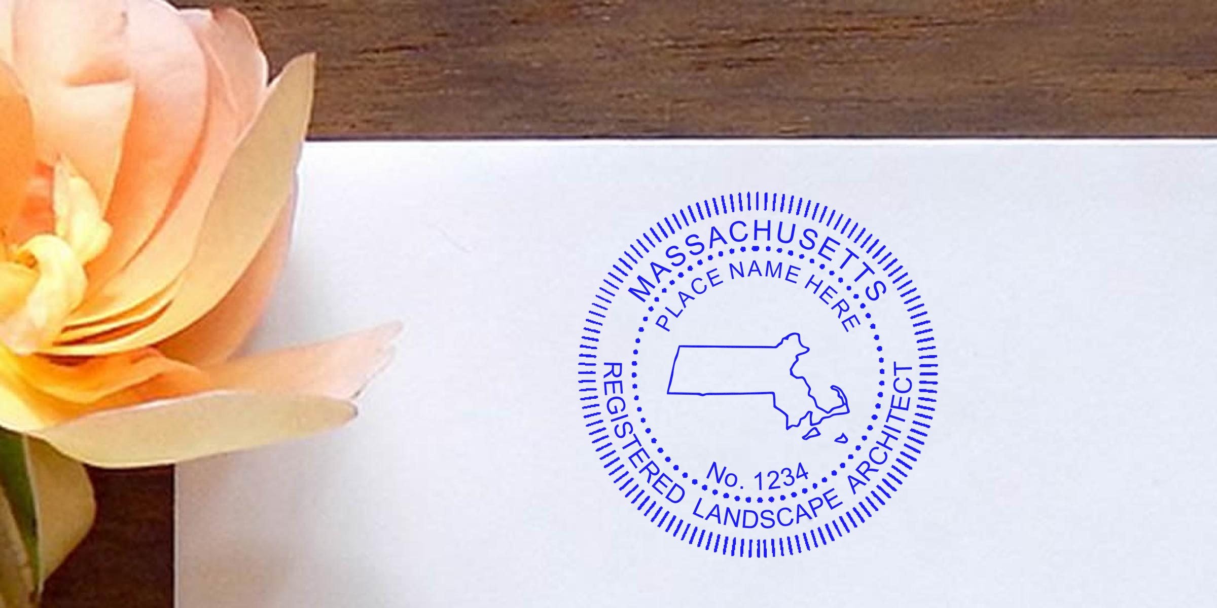 Massachusetts landscape architect seal and Maine stamp with place name and registration number on white paper beside a peach flower, showcasing the Landscape Architect Seal design.