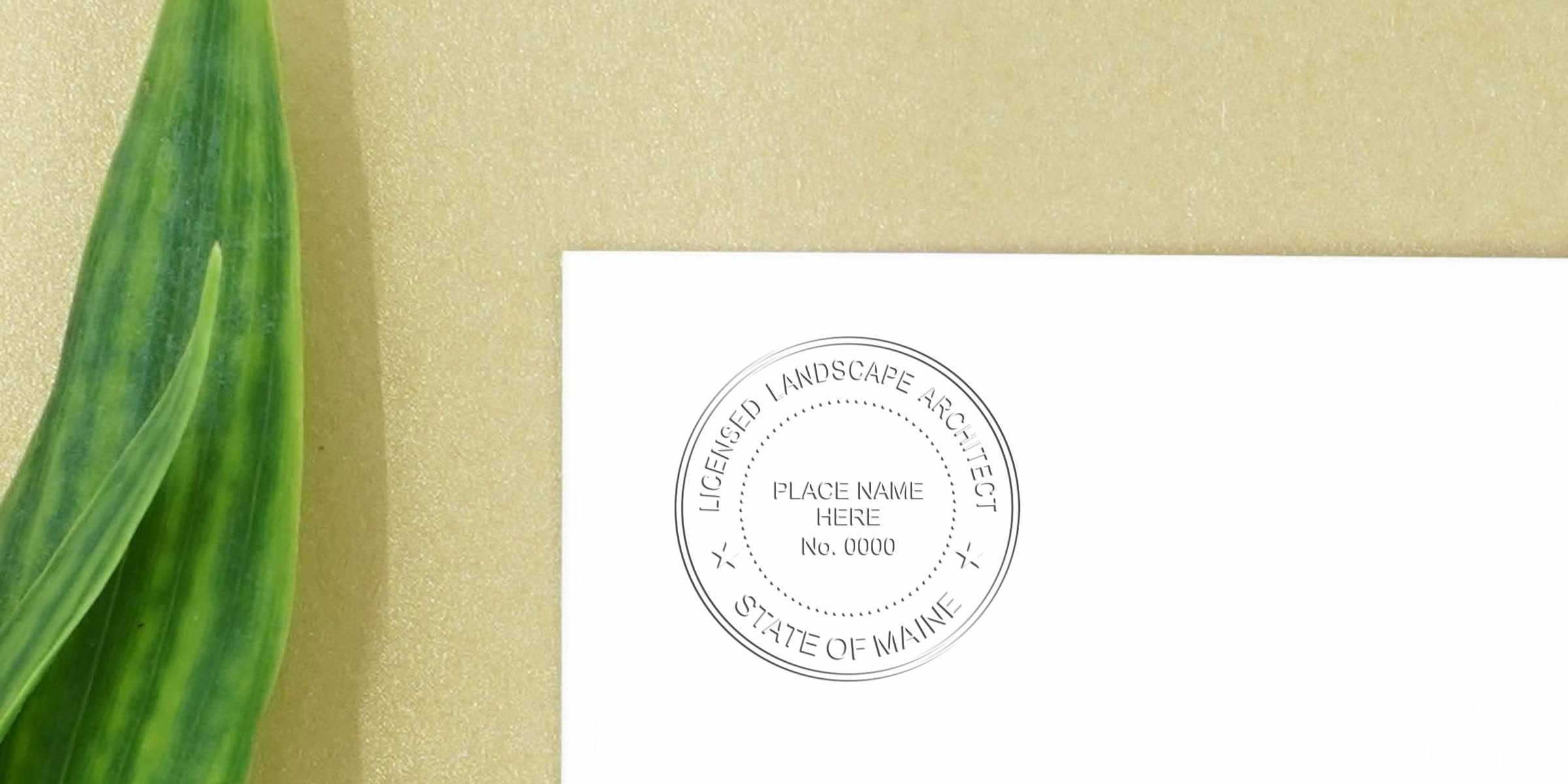 Licensed landscape architect stamp on white paper with green leaf, symbolizing official certification and Maine landscape design licensing requirements.