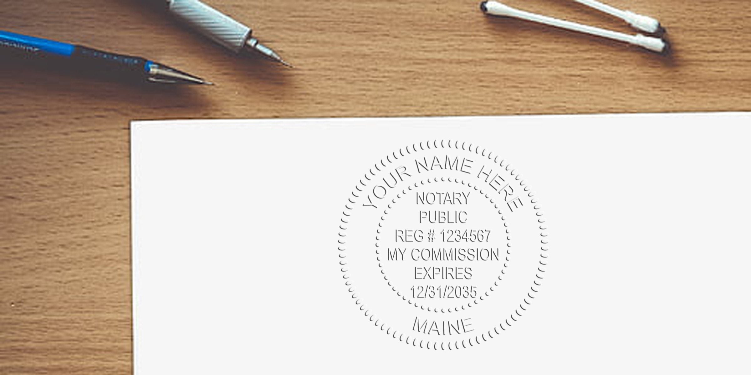 Notary public embossed seal on white paper with pens and cotton swabs on wooden desk, showing Maine notary seal requirements and guidelines.