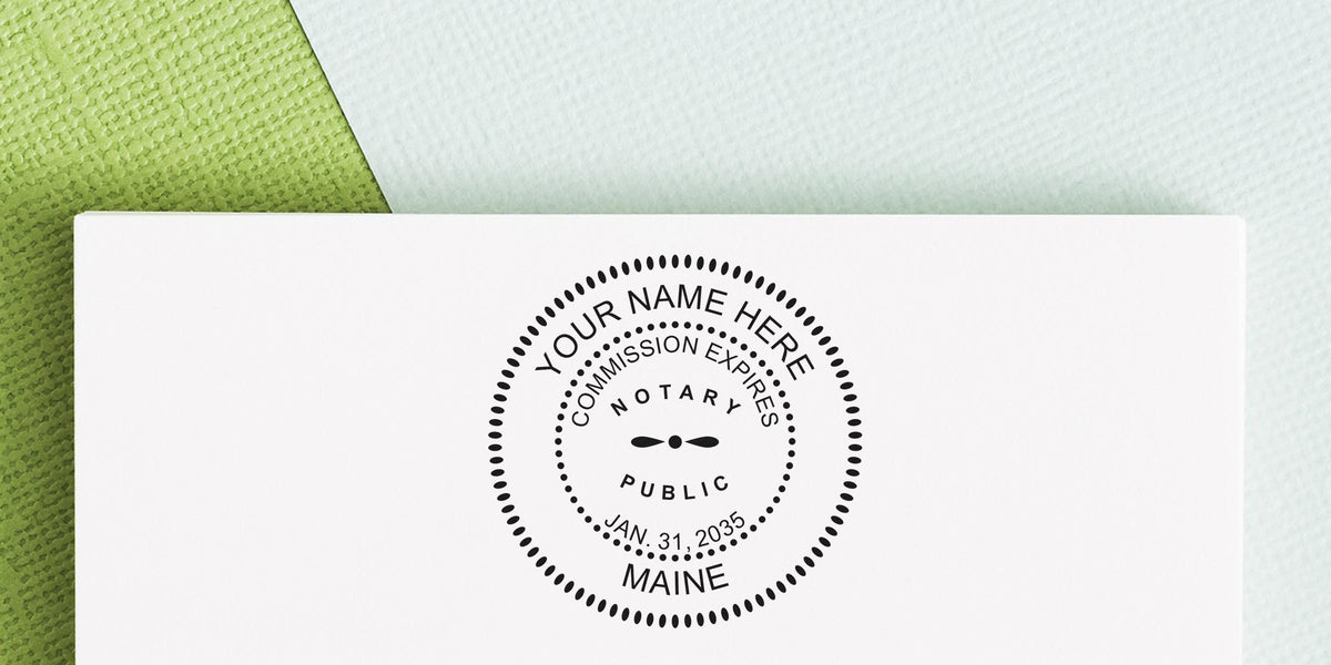 Maine notary public stamp on white paper showing commission expiration date, part of a Maine notary kit with new supplies.