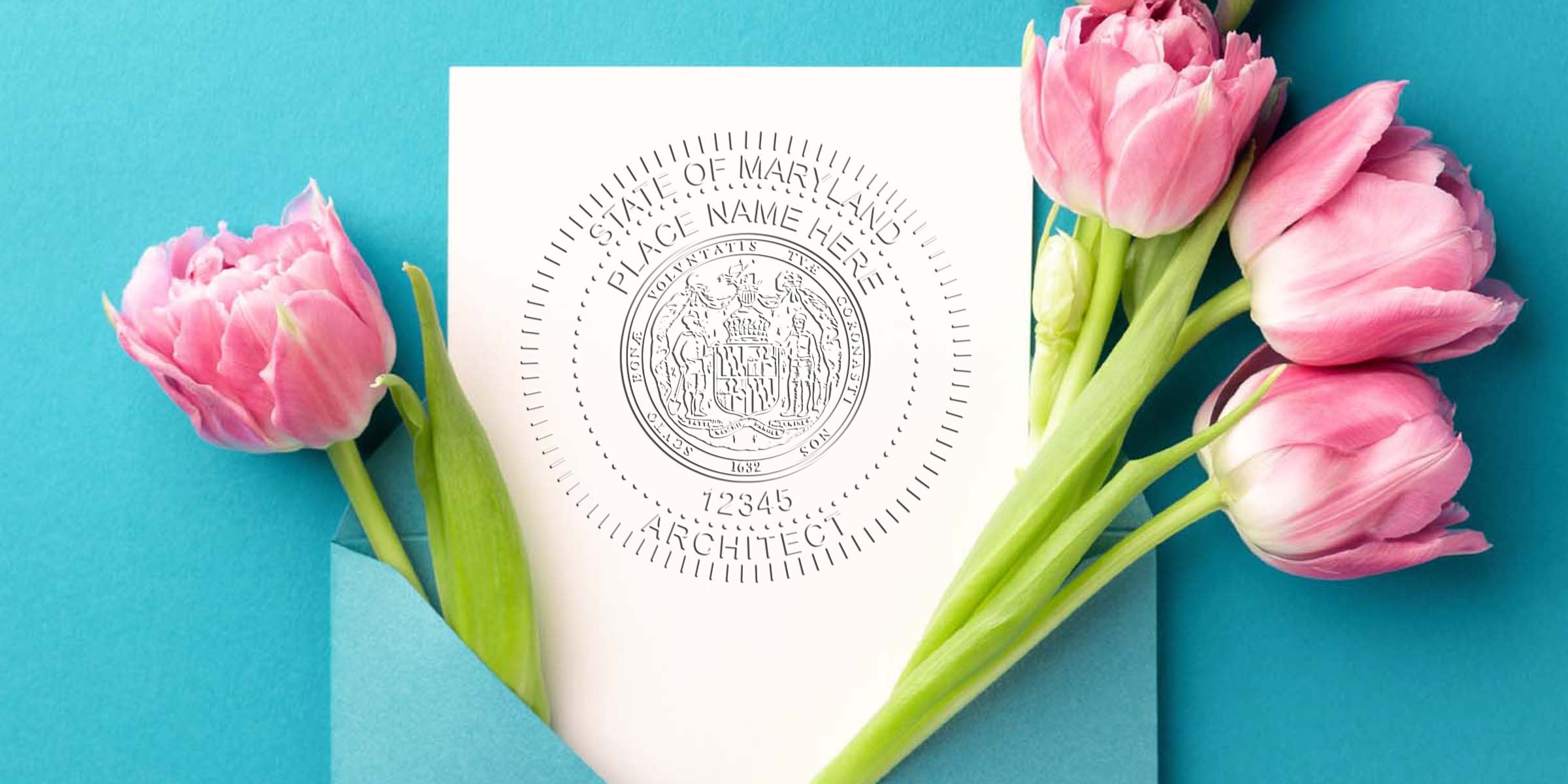 Maryland architect seal on white paper with pink tulips and blue envelope, depicting architect seal renewal and the renewal process.