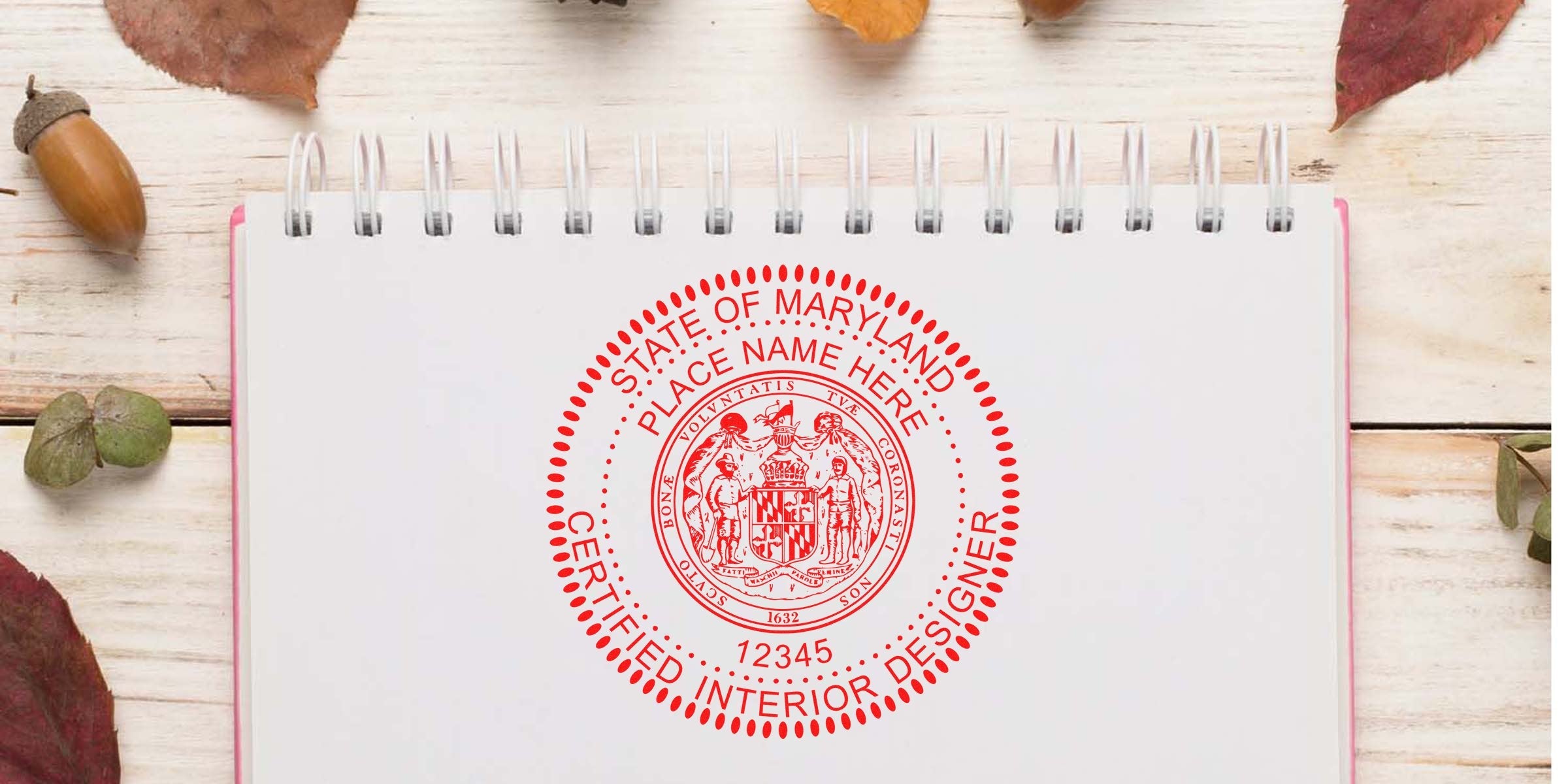 Maryland interior designer stamp on notebook with autumn leaves and acorns on a wooden table, showing stamp sizes and common design stamp errors.