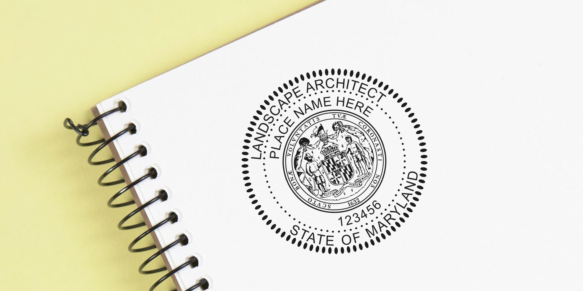 Maryland landscape architect stamp on white spiral notebook with yellow background, symbolizing Maryland landscape architect licensing.