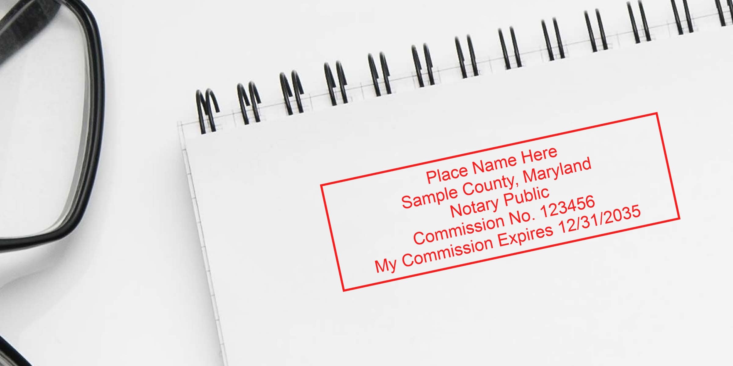 Notary public stamp on spiral notebook with glasses, Maryland notary commission seal, official stamp, legal document authentication, MD notary supplies, essential notary tools.