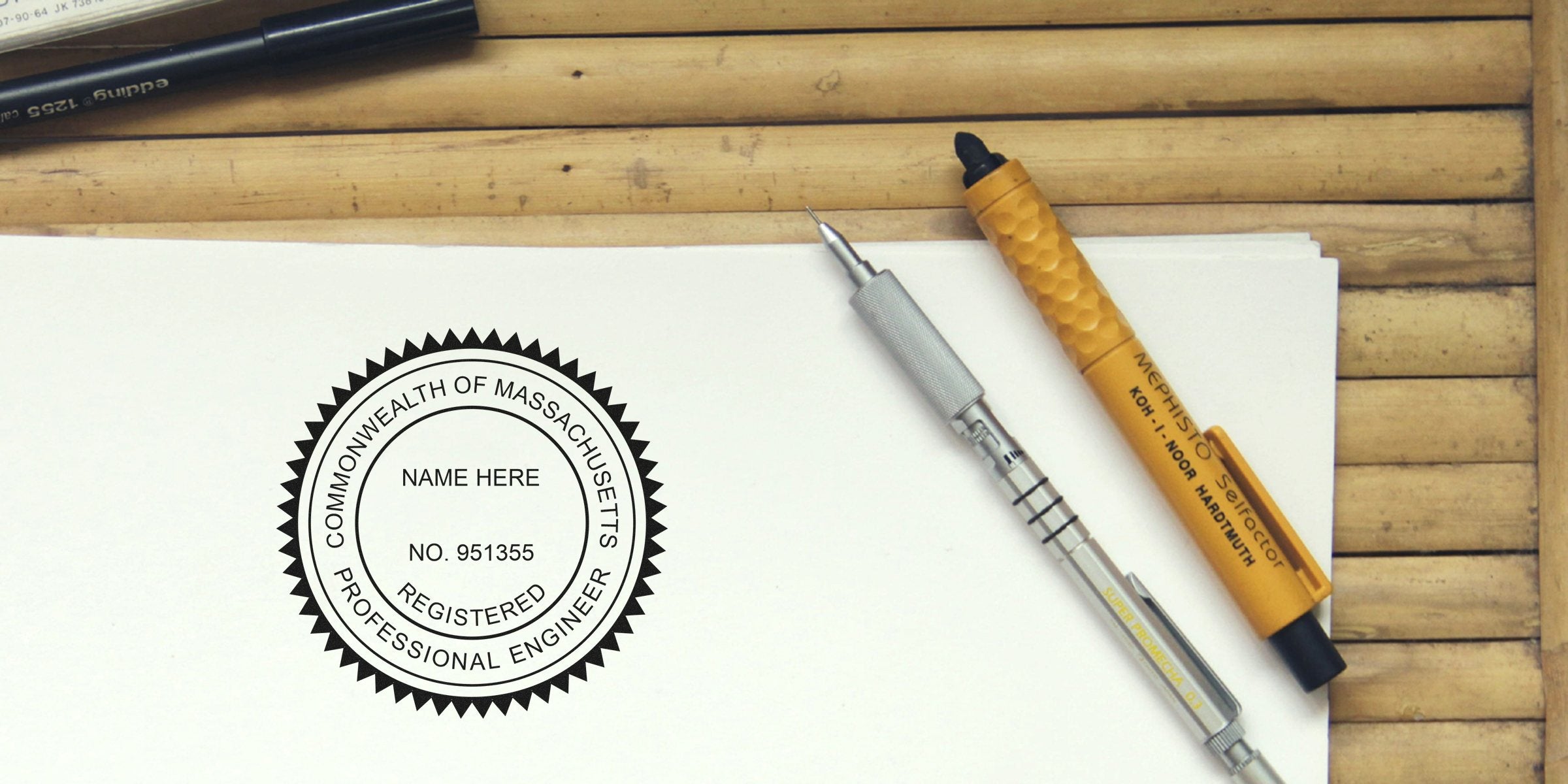 Massachusetts Professional Engineer stamp on paper with drafting pens and wooden background, emphasizing PE license requirements.
