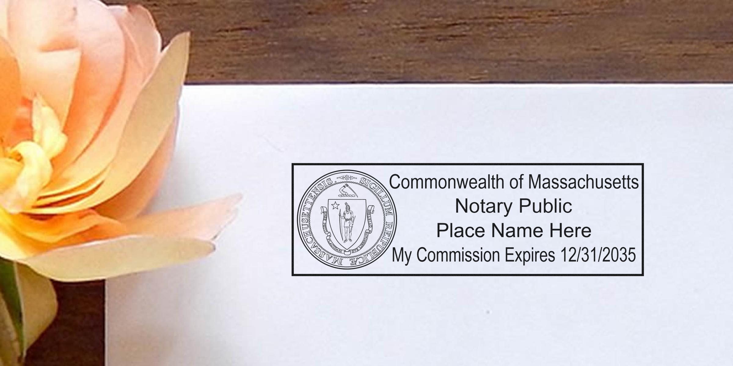 Massachusetts Notary Seal stamp with commission expiration date on white paper next to a peach flower, showcasing Massachusetts Notary Supplies.