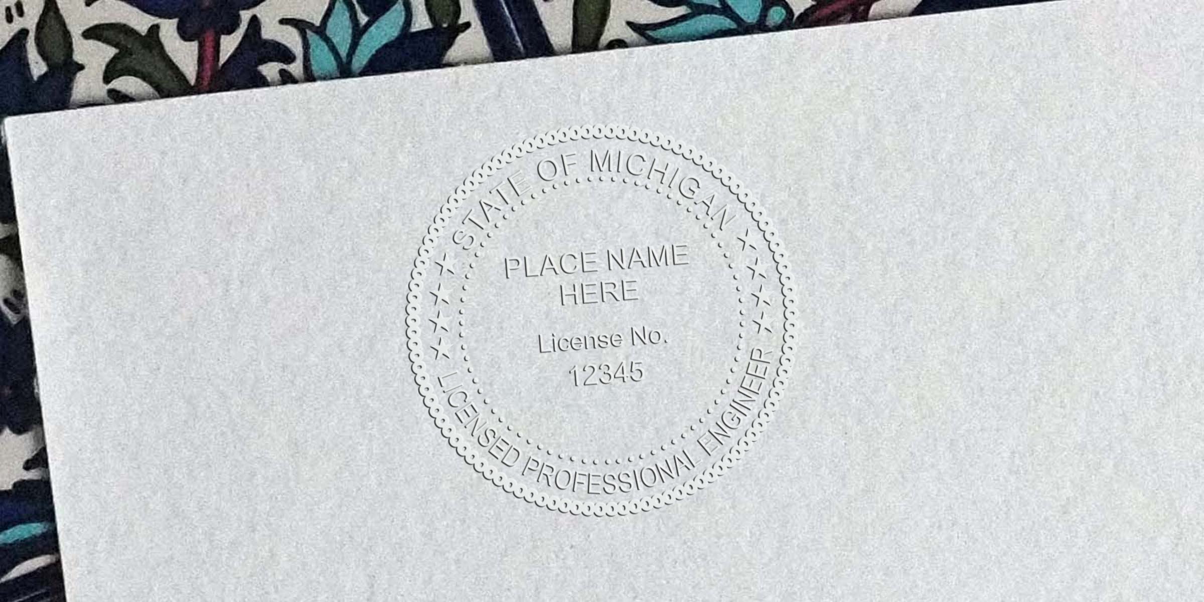 Embossed custom Michigan engineer stamp with licensed professional engineer seal and license number 12345 on official document.