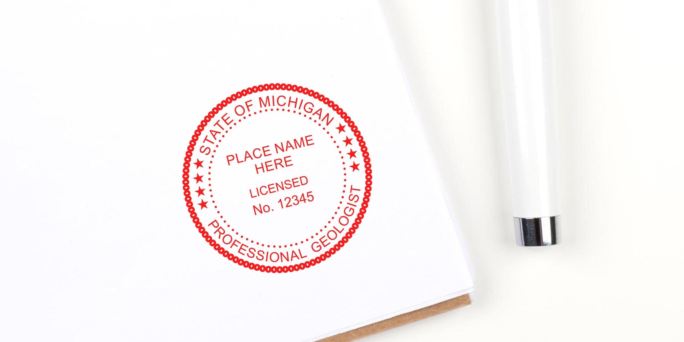 Red Michigan Geologist Stamp on white paper with a white pen nearby, showing the Geologist Stamp Order Process.