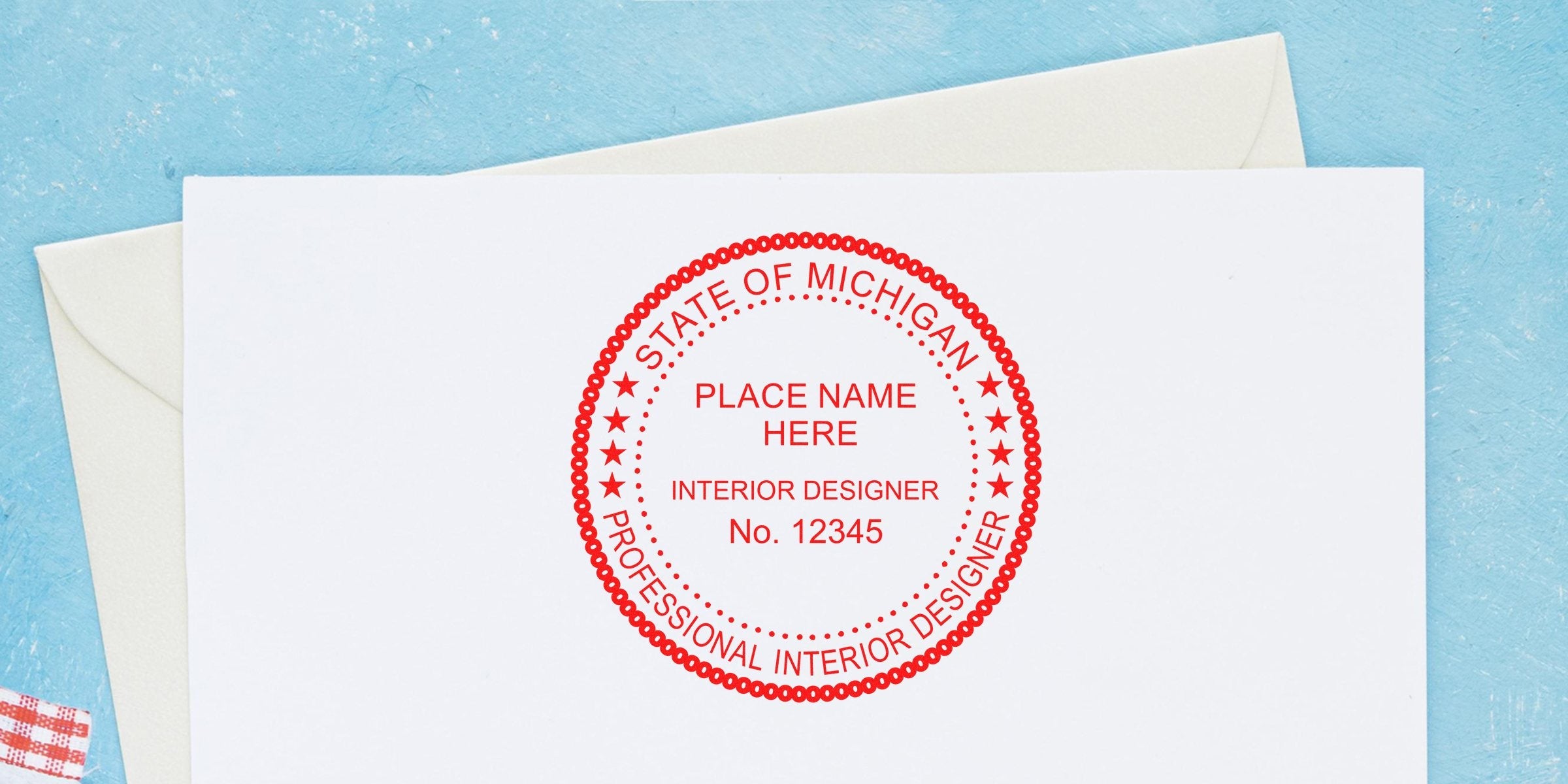 Custom red Interior Designer Stamp Michigan for certification, meets Michigan Interior Design legal requirements, shown on white paper with envelope.