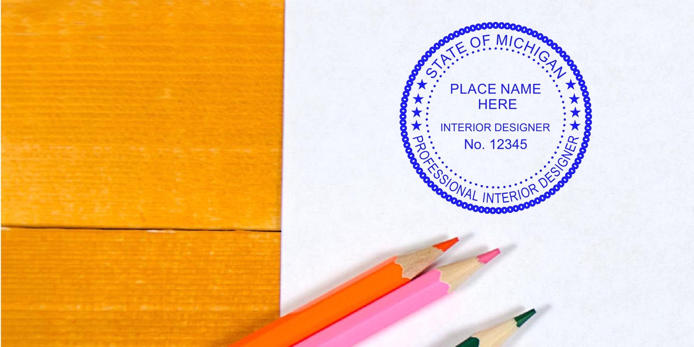 Michigan interior designer seal stamped on paper with colored pencils on a wooden table, symbolizing interior design certification in Michigan.