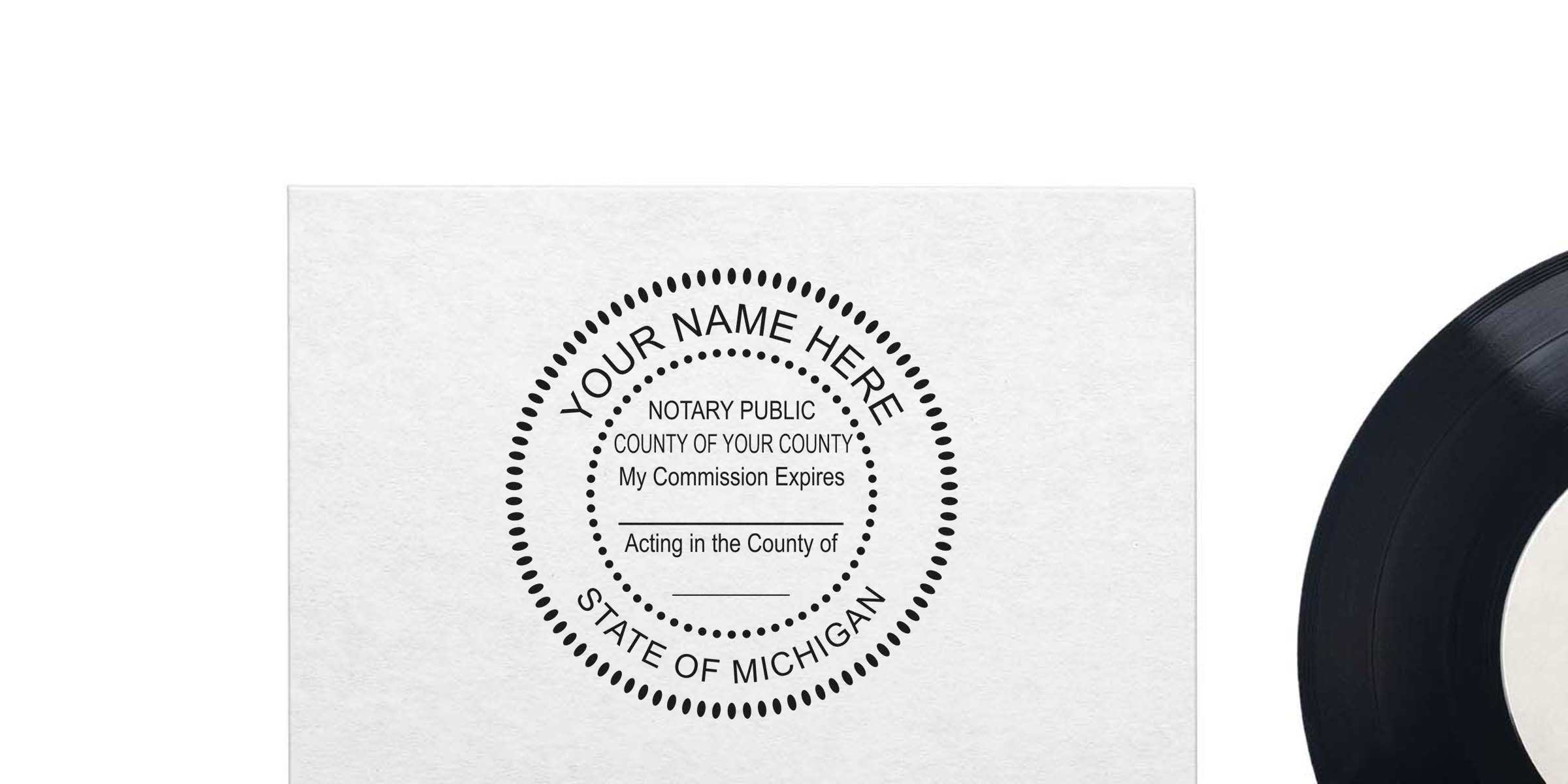 Michigan notary seal stamp on white paper with vinyl record edge visible, perfect for buying a notary seal.