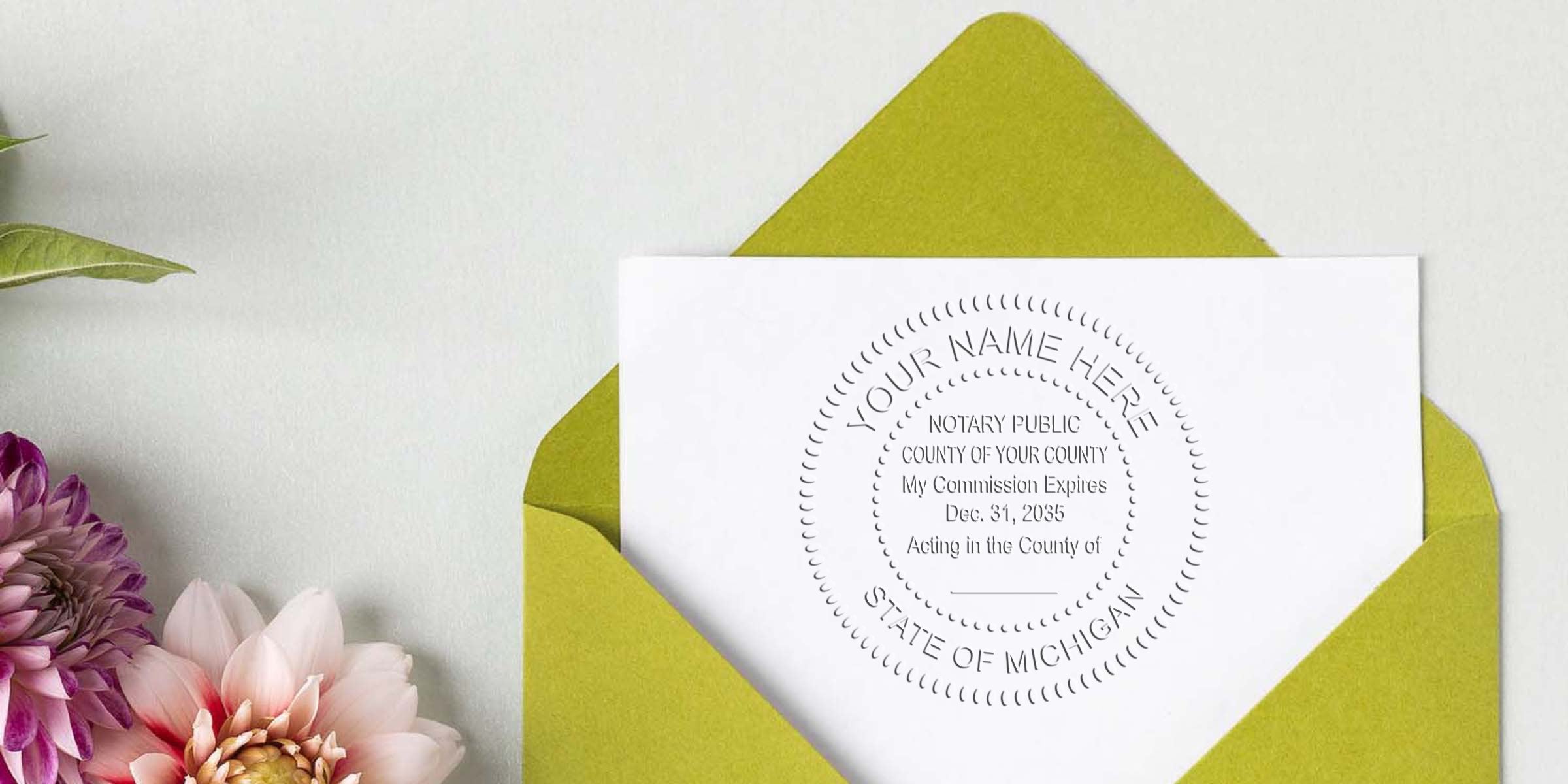 Michigan notary kit includes a notary seal on white paper, green floral envelope, Michigan notary commission certificate, and official notary stamp—essential starter tools for notaries.