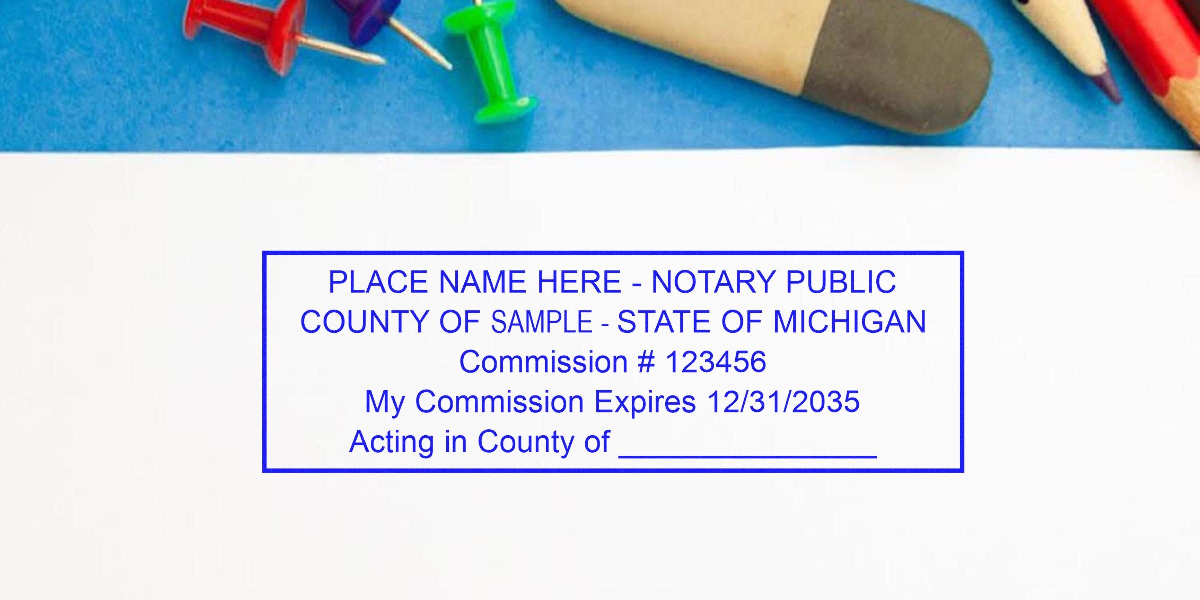 Michigan notary seal stamped on white paper with commission number, expiration date, and seal dimensions, surrounded by office supplies.