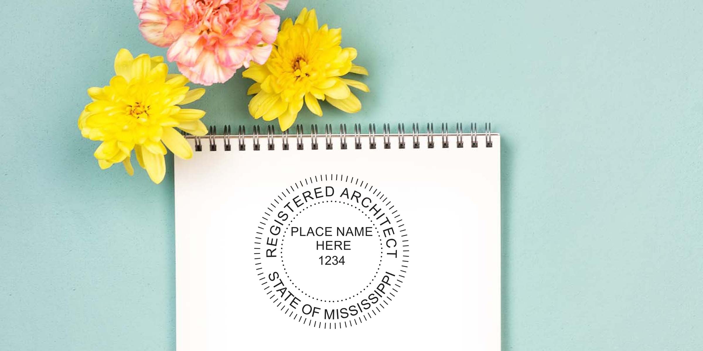 Mississippi Architectural Embossed Stamp on white notebook with yellow and pink flowers on blue background, showing embossed stamp use.