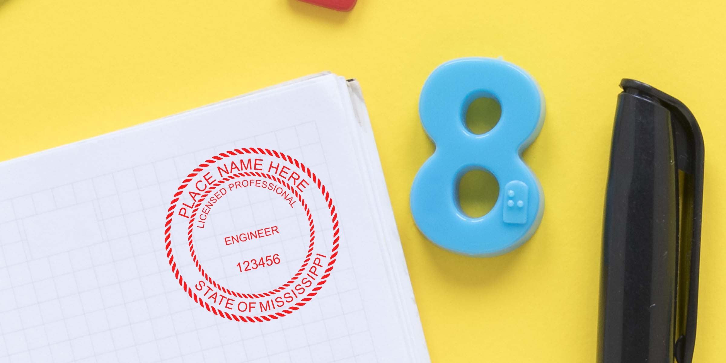 Professional Engineer Stamp Mississippi on notebook with blue number 8 and black stapler on yellow background, showing PE Stamp Mississippi.