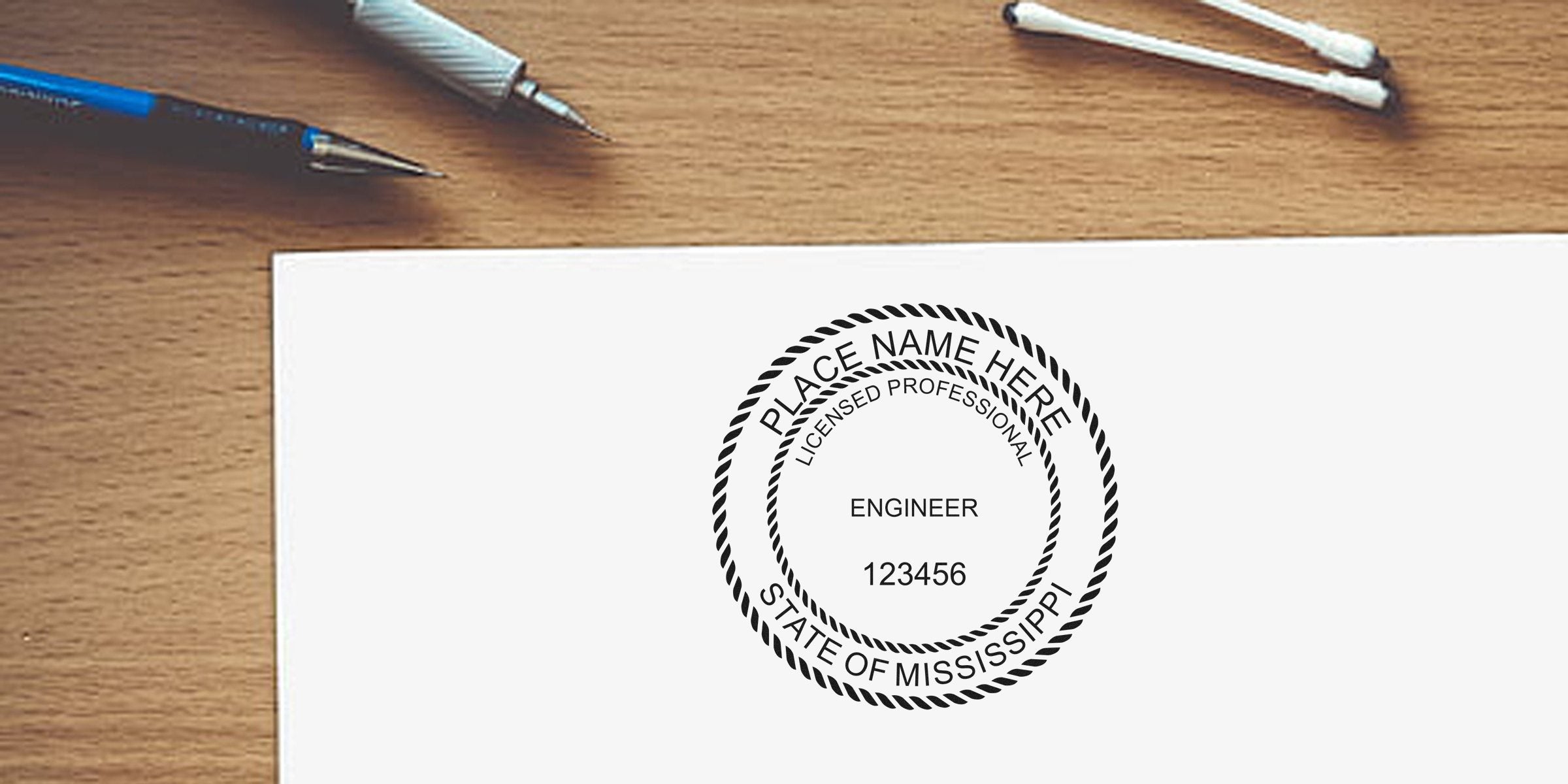 Mississippi engineer stamp on wooden desk with pens and cotton swabs, highlighting trusted engineer certification.