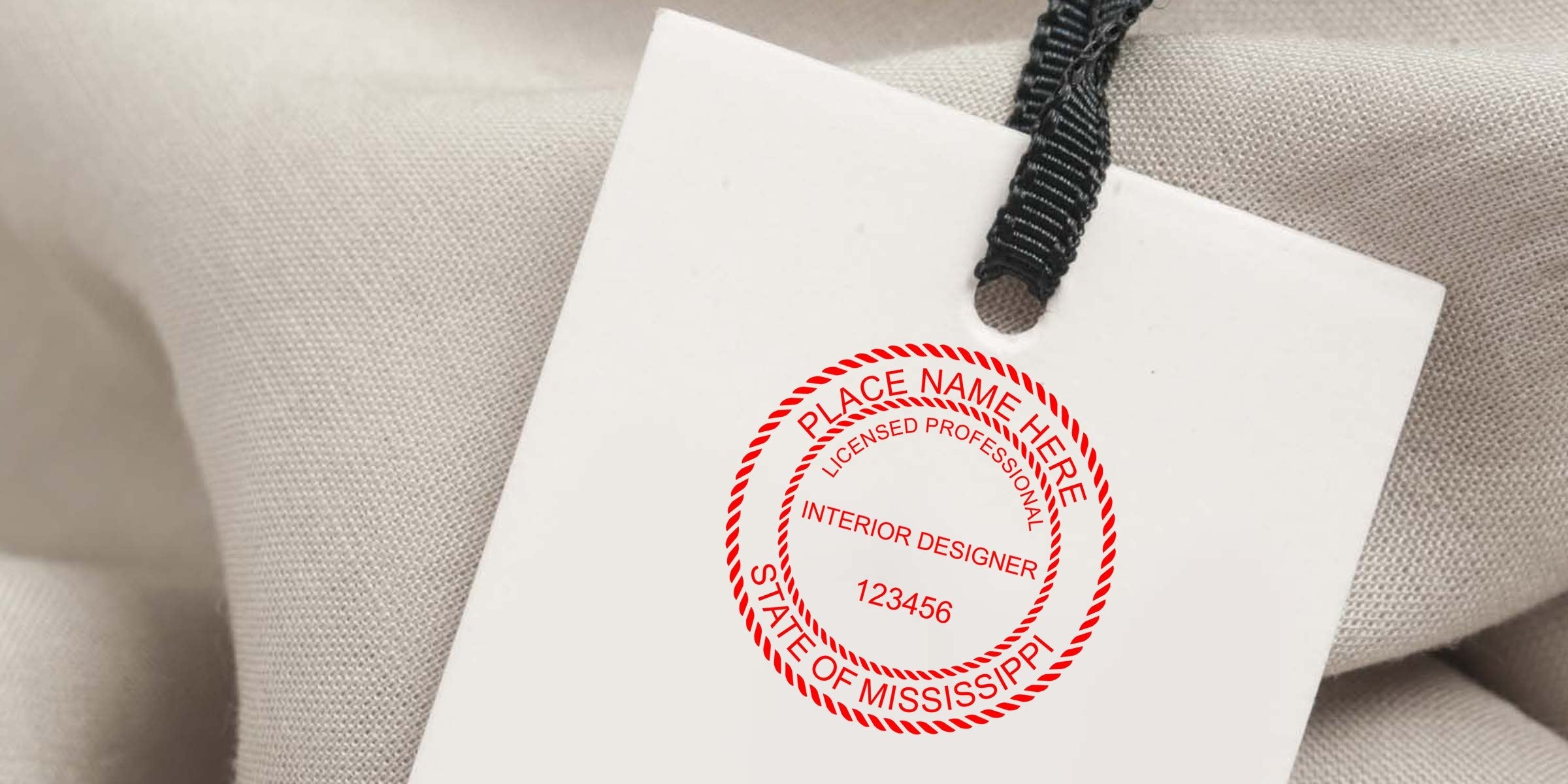Mississippi Interior Designer stamp on fabric tag with black string, displaying the official license to enhance interior design work.