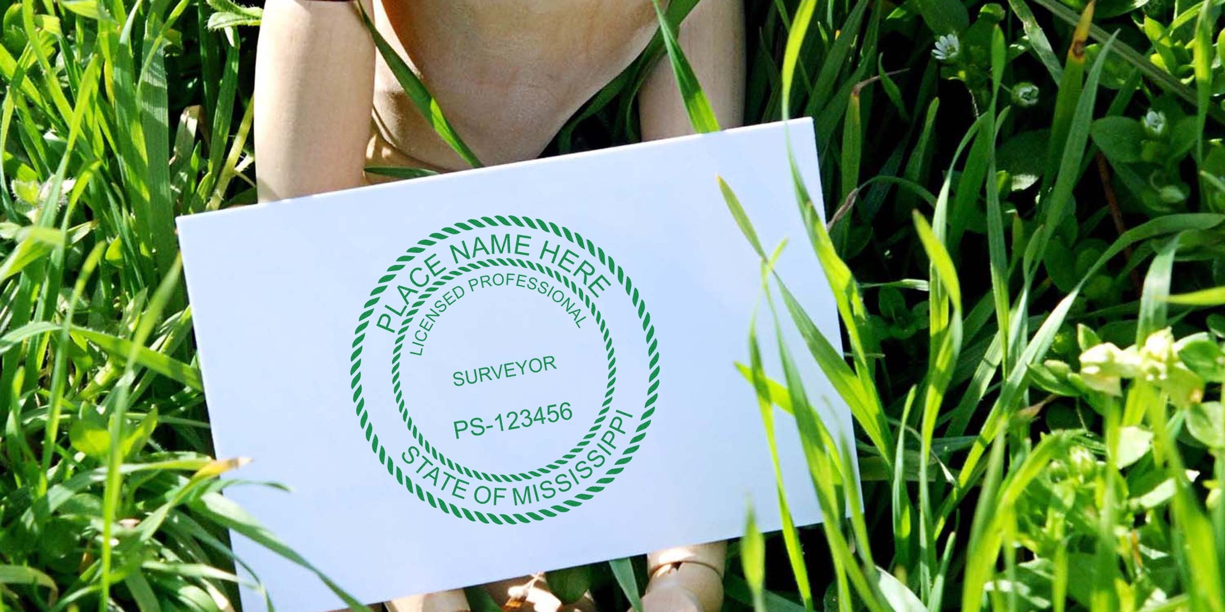 Mississippi land surveyor seal in green ink on white paper, showing licensed professional surveyor design, encircled by grass and plants.